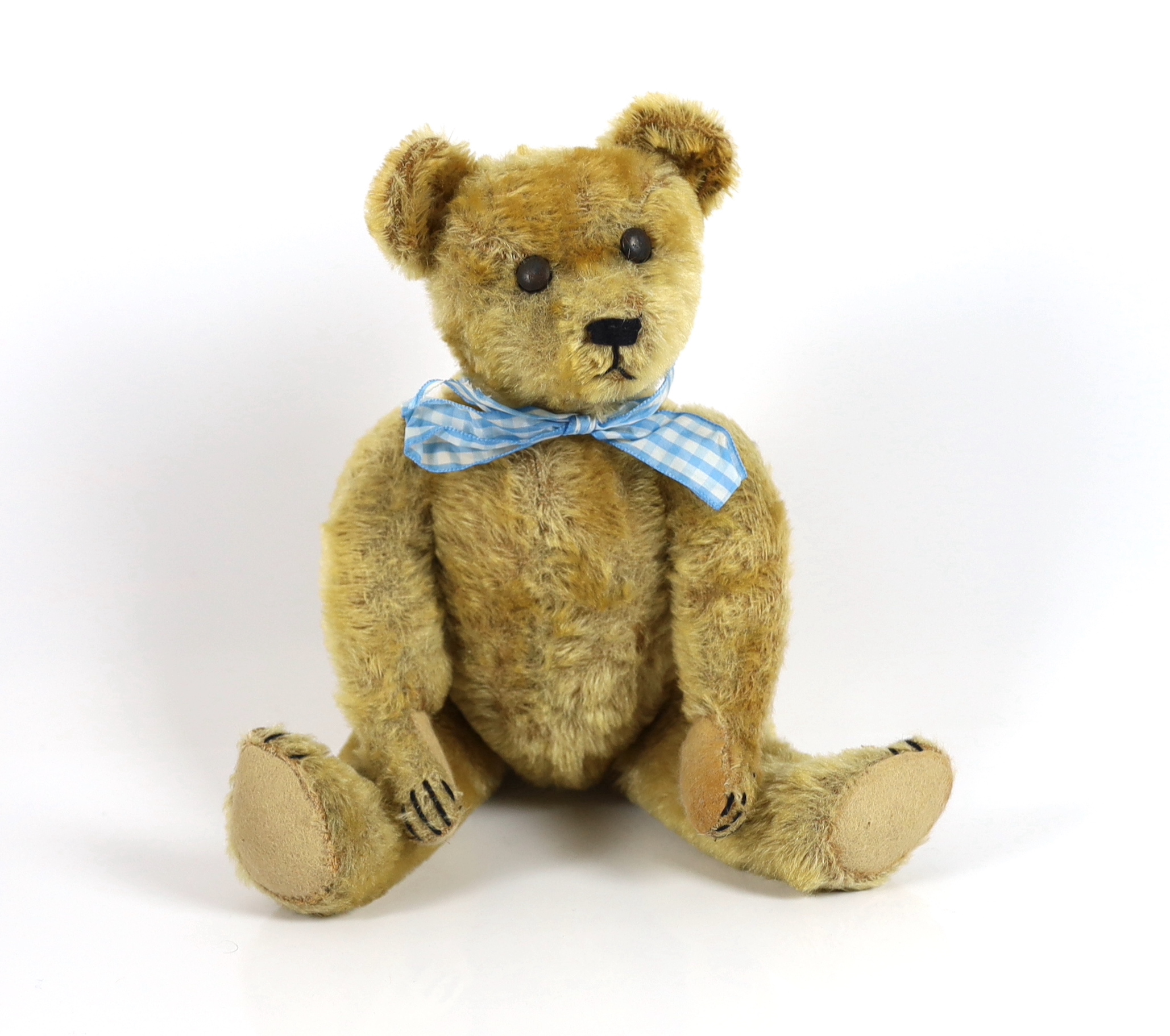 An early German bear, c.1920, with set in ears, black button eyes, 35cm, replaced paw pads, otherwise good condition